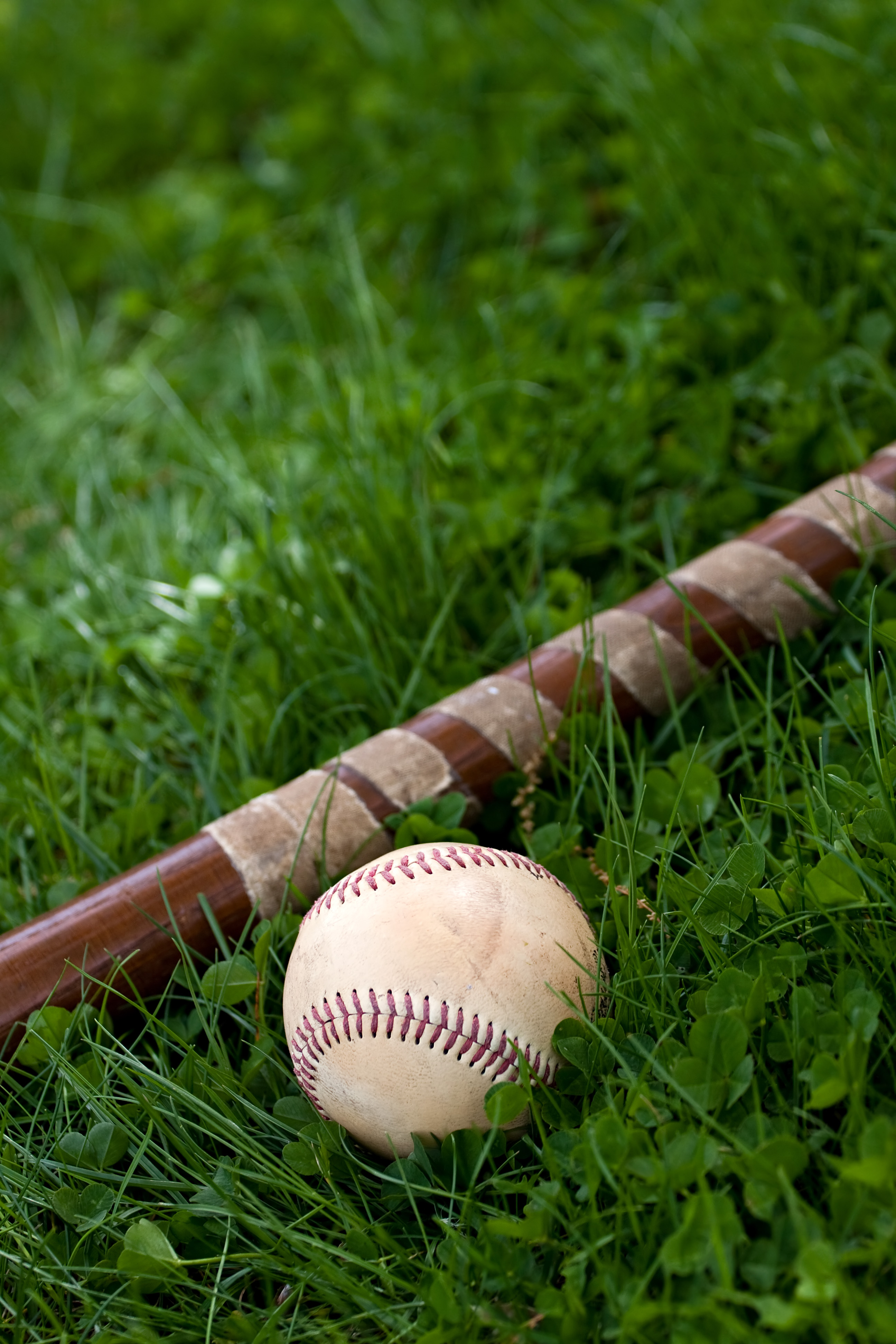 an old wooden baseball bat and ball