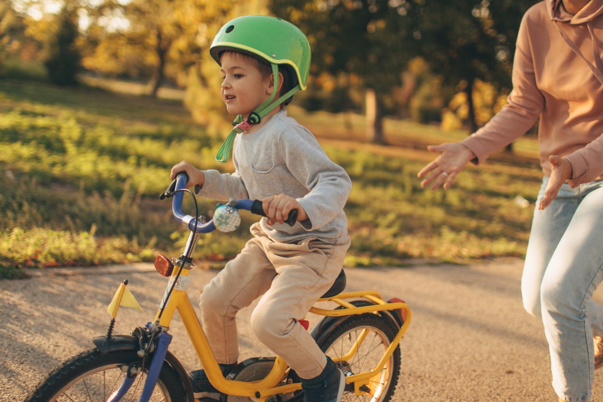 boy learning to ride a bicycle picture id860037378